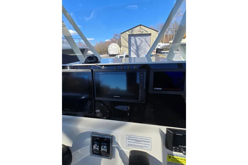 Slide: The Image of 2020 Cobia 220 Center Console boat dashboard with Garmin and Yamaha displays. - 15