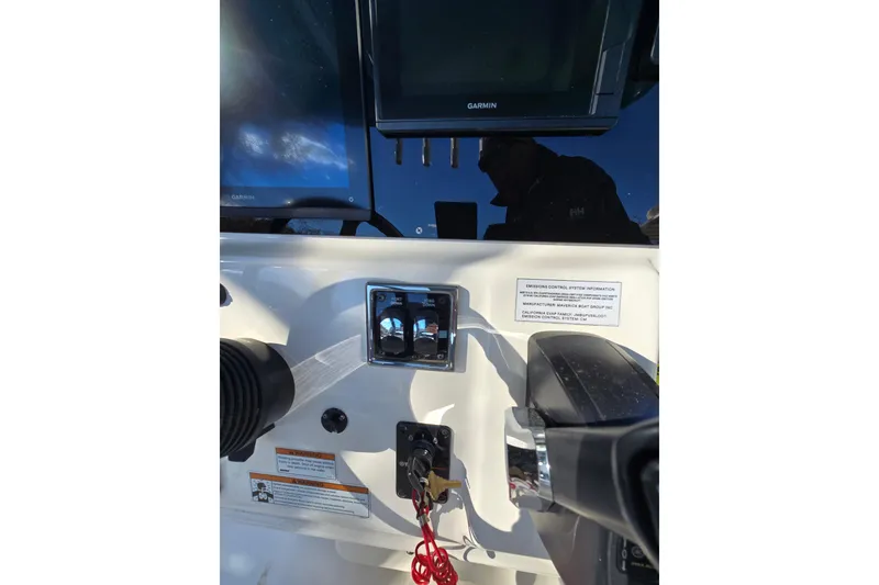 Slide: The Image of 2020 Cobia 220 Center Console dashboard with Garmin navigation system and control panel. - 17