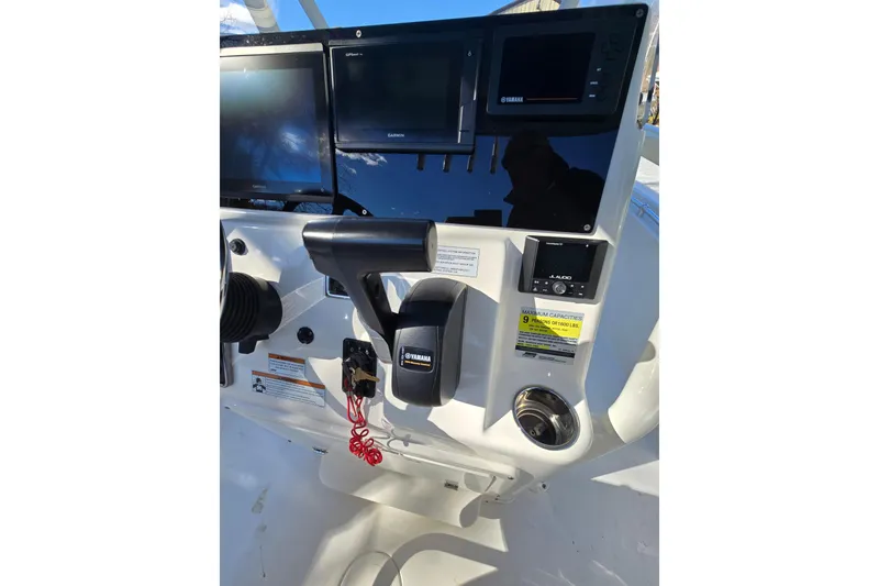 Slide: The Image of 2020 Cobia 220 Center Console boat dashboard with Garmin displays and Yamaha controls. - 18