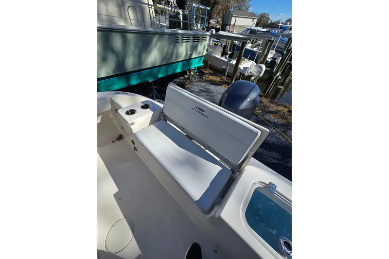 Slide: The Image of 2020 Cobia 220 Center Console boat interior with seating and cup holders. - 23