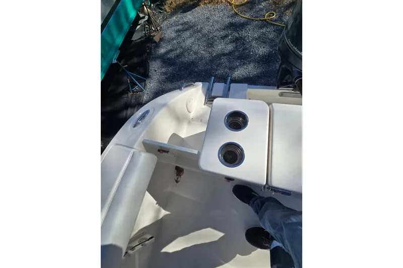Slide: The Image of 2020 Cobia 220 Center Console boat interior with cup holders and seating. - 24