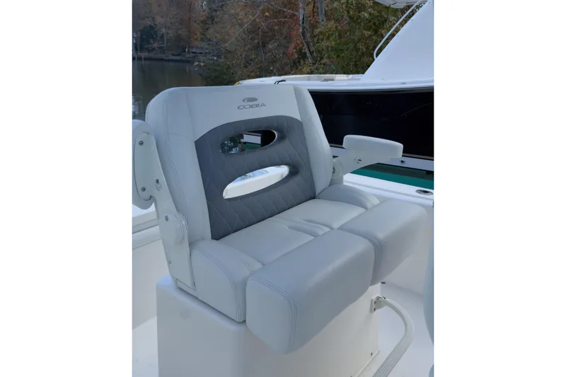 Slide: The Image of 2020 Cobia 220 Center Console boat on calm water, featuring a sleek design. - 4