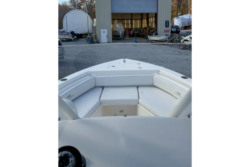 Slide: The Image of 2020 Cobia 220 Center Console boat with Yamaha 200 engine, parked outdoors. - 5