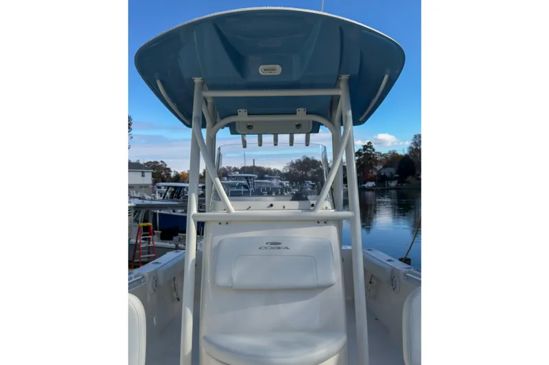 Slide: The Image of 2020 Cobia 220 Center Console boat interior with compact marine toilet. - 6