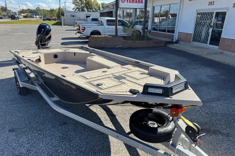 Slide: The Image of 2026 Avid 18 Commander boat on trailer outside dealership, featuring sleek design and modern features. - 1