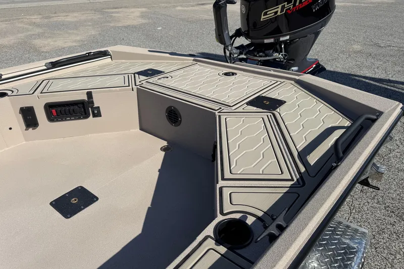Slide: The Image of 2026 Avid 18 Commander boat interior with storage compartments and Yamaha outboard motor. - 11