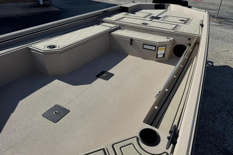 Slide: The Image of 2026 Avid 18 Commander boat interior with storage compartments and rod holders. - 12