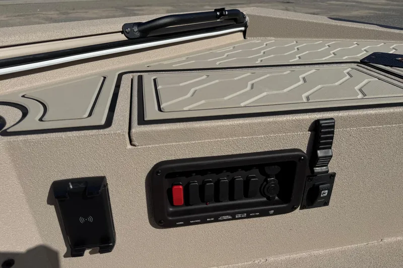 Slide: The Image of Control panel of 2026 Avid 18 Commander boat with switches and textured surface. - 16