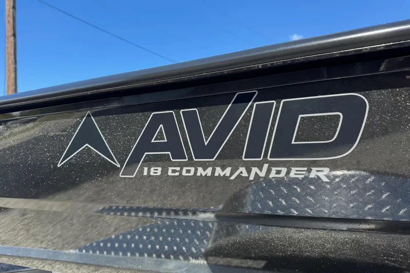 Slide: The Image of 2026 Avid 18 Commander logo on a sleek, metallic surface under clear blue sky. - 5