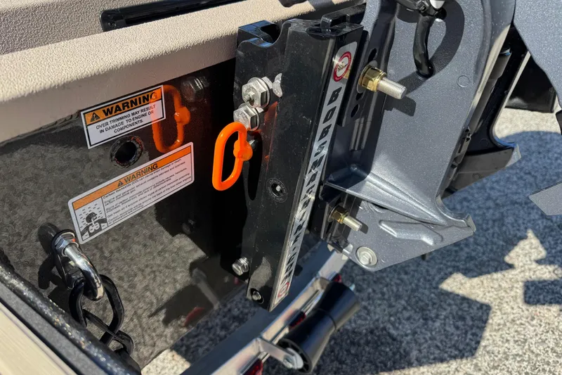 Slide: The Image of 2026 Avid 18 Commander boat engine mount with warning labels and hardware details. - 9