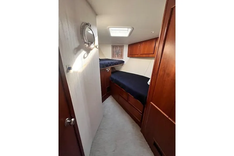 Slide: The Image of 1995 Post 50 Convertible yacht cabin with wooden interior and bunk beds. - 20