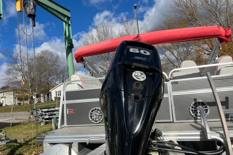 Slide: The Image of Apex Avanti 820 boat with 60 HP engine, docked outdoors under blue sky. - 9