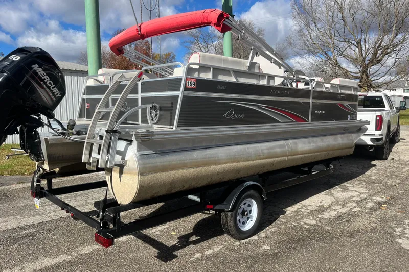 Slide: The Image of 2020 Apex Avanti 820 pontoon boat on trailer, featuring a Mercury outboard motor. - 10