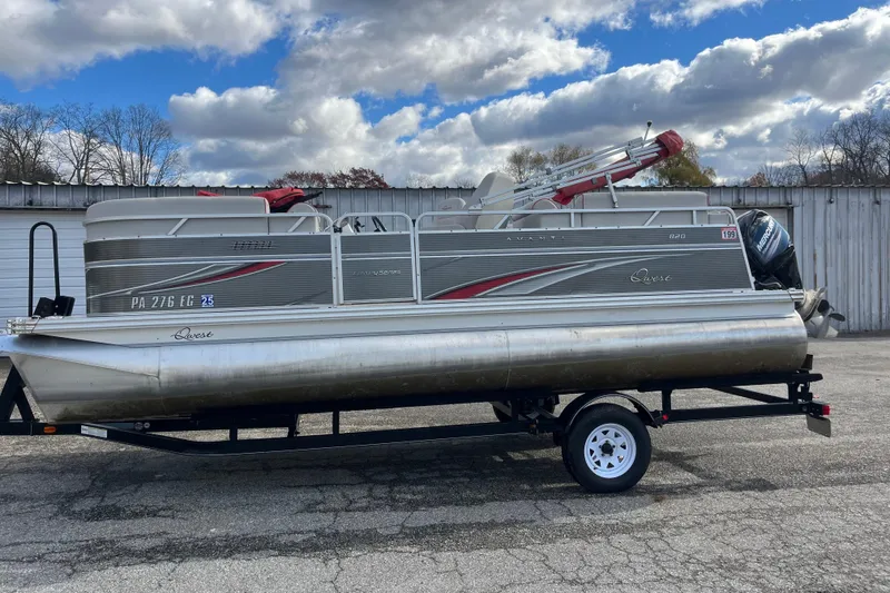 Slide: The Image of 2020 Apex Avanti 820 pontoon boat on trailer, parked outdoors under cloudy sky. - 7