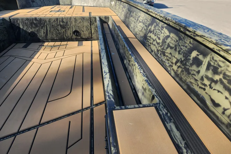 Slide: The Image of 2026 Tracker Grizzly 1756 T Marsh boat interior with camouflage design and tan flooring. - 10