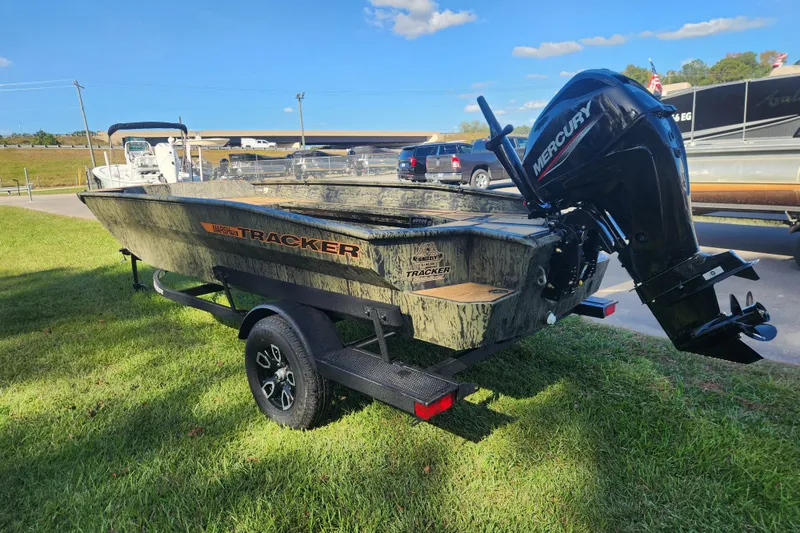 Slide: The Image of 2026 Tracker Grizzly 1756 T Marsh boat with Mercury engine on trailer, parked on grass. - 4