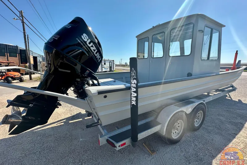 Slide: The Image of 2024 SeaArk 2672 Workhorse boat with Suzuki outboard engine on a trailer. - 2