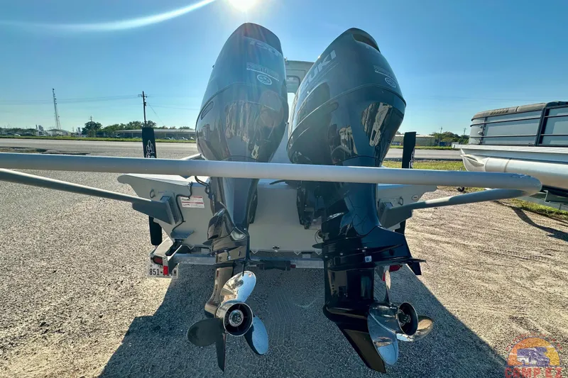 Slide: The Image of 2024 SeaArk 2672 Workhorse boat with Suzuki four-stroke outboard motor, parked outdoors. - 5