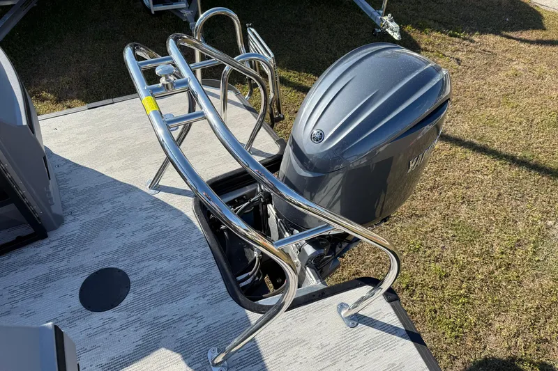 Slide: The Image of 2026 Sylvan R22 boat with chrome railings and outboard motor on deck. - 15