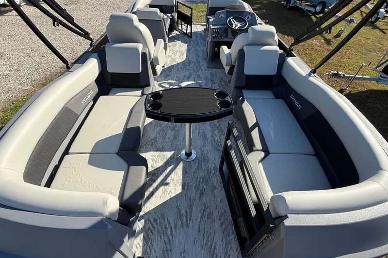 Slide: The Image of 2026 Sylvan R22 boat interior with plush seating and central table. - 3
