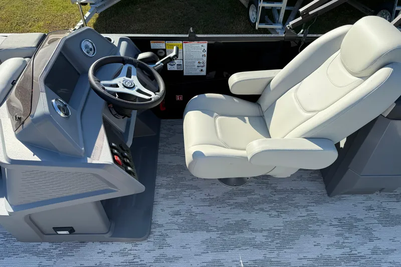 Slide: The Image of Captain's seat and steering console of 2026 Sylvan R22 boat, featuring modern design. - 8