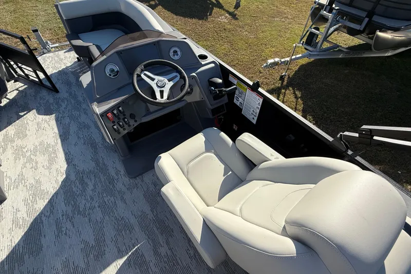 Slide: The Image of Interior of 2026 Sylvan R22 boat with modern steering console and seating. - 9