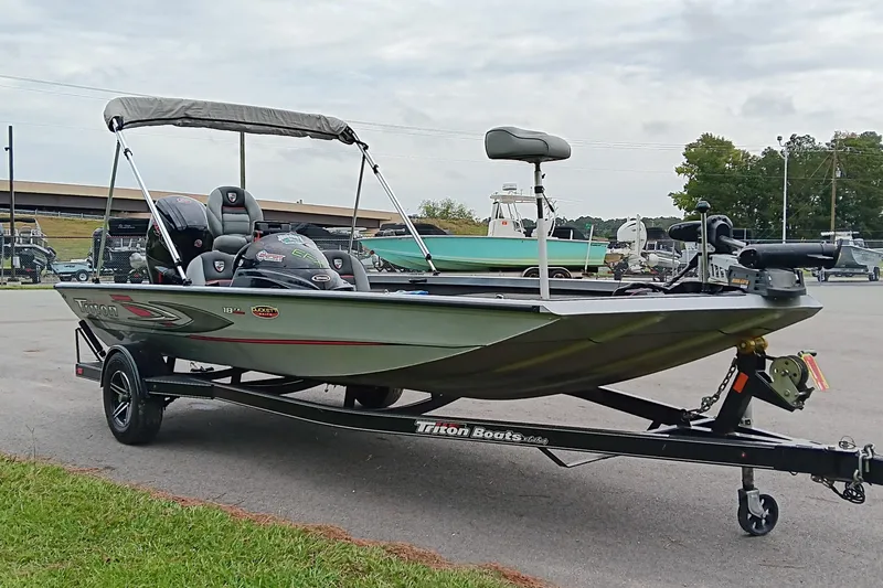 Slide: The Image of 2017 Triton 18 C TX boat on trailer, parked outdoors. - 5