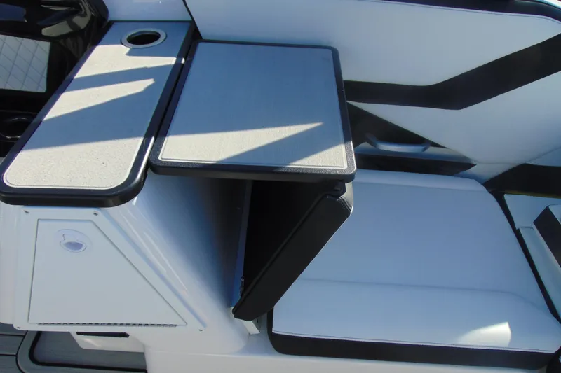 Slide: The Image of 2026 Yamaha Boats 252SD interior seating with foldable table and cup holder. - 13