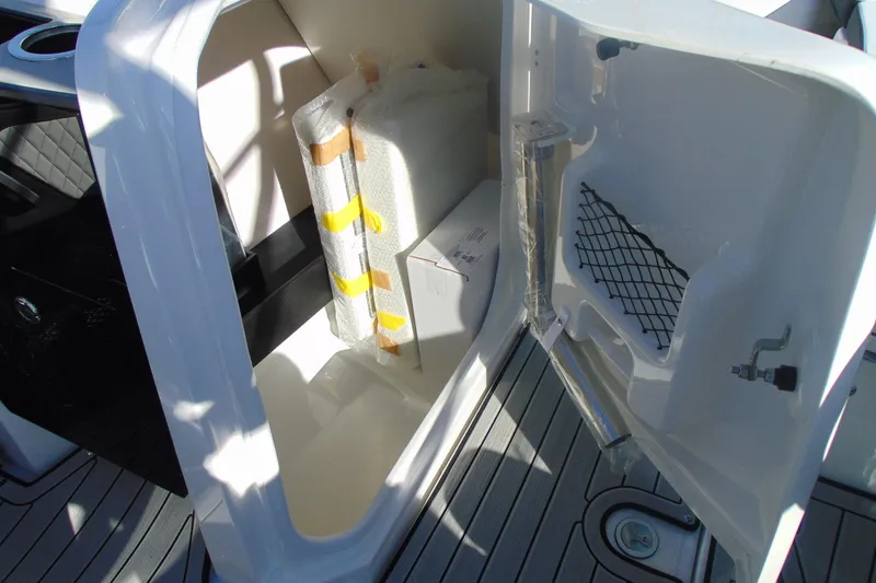 Slide: The Image of Storage compartment in 2026 Yamaha Boats 252SD, featuring organized interior and secure netting. - 21