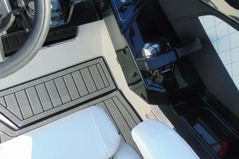 Slide: The Image of Interior view of 2026 Yamaha Boats 252SD, featuring steering wheel and throttle controls. - 26