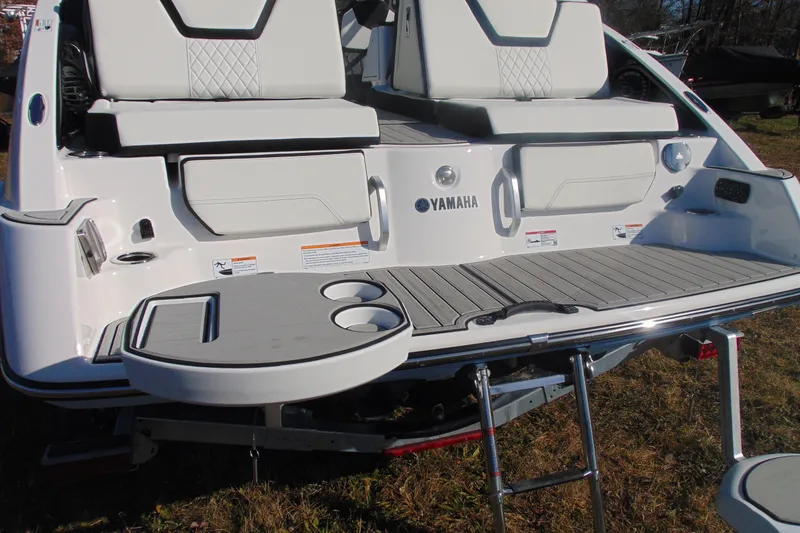 Slide: The Image of 2026 Yamaha Boats 252SD rear view with seating, swim platform, and table. - 9