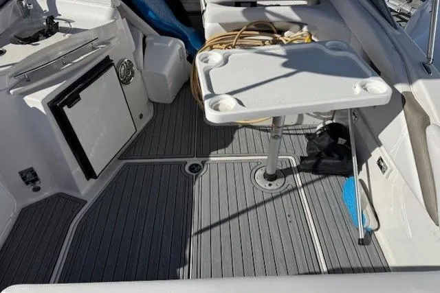 Slide: The Image of 2016 Glastron GS 289 boat interior with table and seating area. - 12