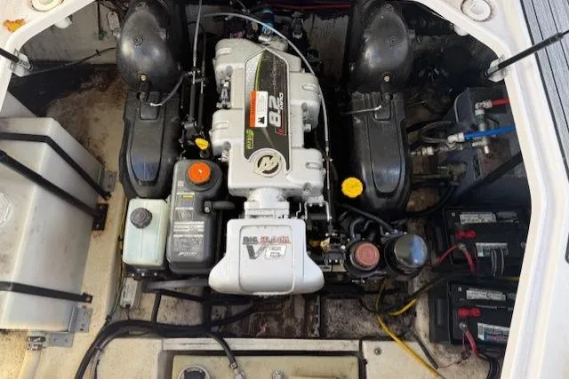 Slide: The Image of Engine compartment of a 2016 Glastron GS 289 boat, showcasing the engine and components. - 14