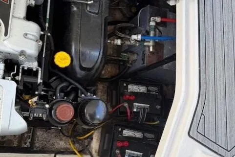 Slide: The Image of Engine compartment of a 2016 Glastron GS 289 boat, showing batteries and mechanical components. - 15