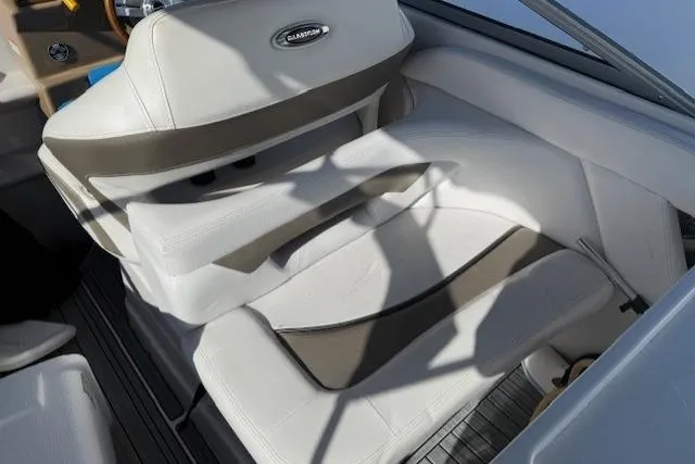 Slide: The Image of 2016 Glastron GS 289 boat interior with white and beige seating. - 18