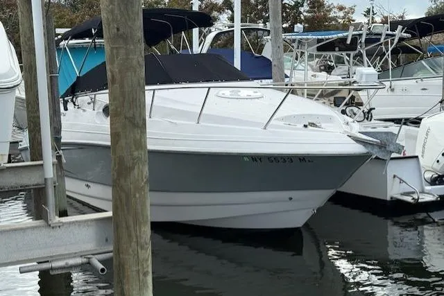 Slide: The Image of 2016 Glastron GS 289 boat docked in marina, featuring sleek design and black canopy. - 2