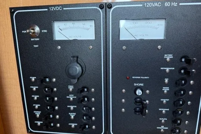 Slide: The Image of Electrical control panel on 2016 Glastron GS 289 boat, featuring 12VDC and 120VAC systems. - 24