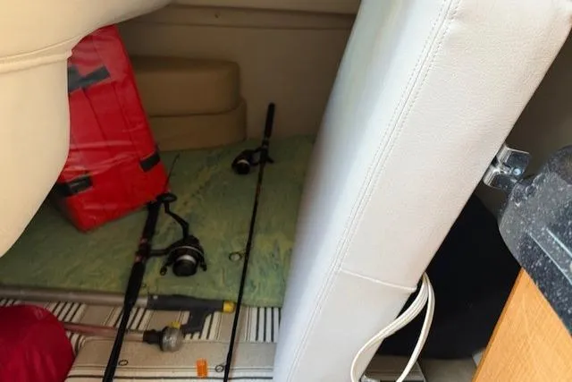 Slide: The Image of 2016 Glastron GS 289 cabin interior with fishing rods and life jacket. - 25