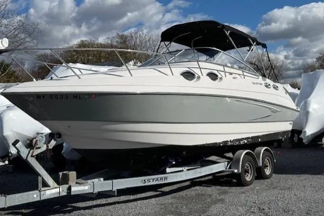 Slide: The Image of 2016 Glastron GS 289 boat on trailer under cloudy sky. - 7