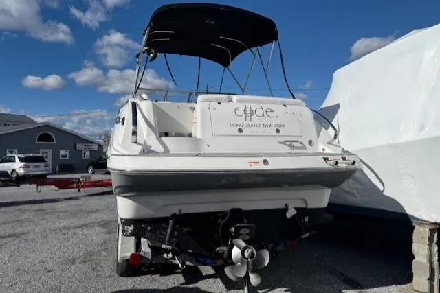 Slide: The Image of 2016 Glastron GS 289 boat with canopy, parked outdoors under a blue sky. - 9