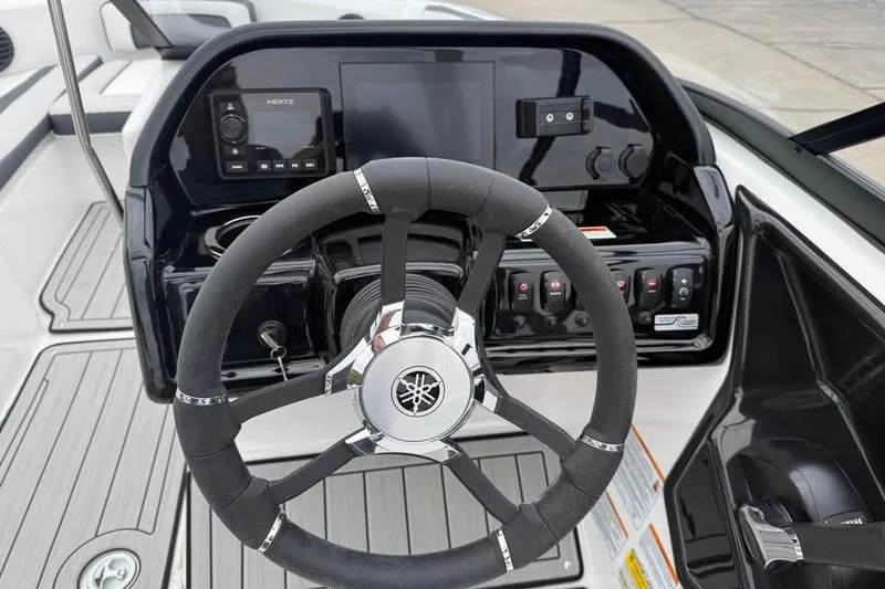 Slide: The Image of 2026 Yamaha Boats 195S on trailer, parked outdoors with autumn trees in background. - 3