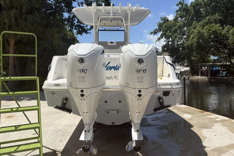 Slide: The Image of 2023 Robalo R302 Center Console boat with dual 300 V6 engines docked outdoors. - 3