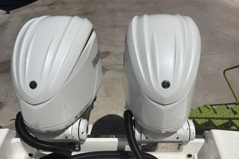 Slide: The Image of Twin Yamaha outboard engines on a 2023 Robalo R302 Center Console boat. - 8