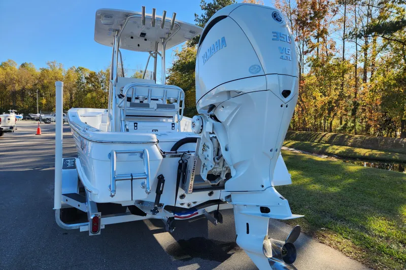 Slide: The Image of 2026 BlackJack 256 Bay boat with Yamaha 350 V6 engine, parked outdoors. - 3