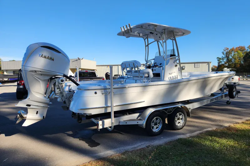 Slide: The Image of 2026 BlackJack 256 Bay boat on trailer with Yamaha outboard motor, parked outdoors. - 4