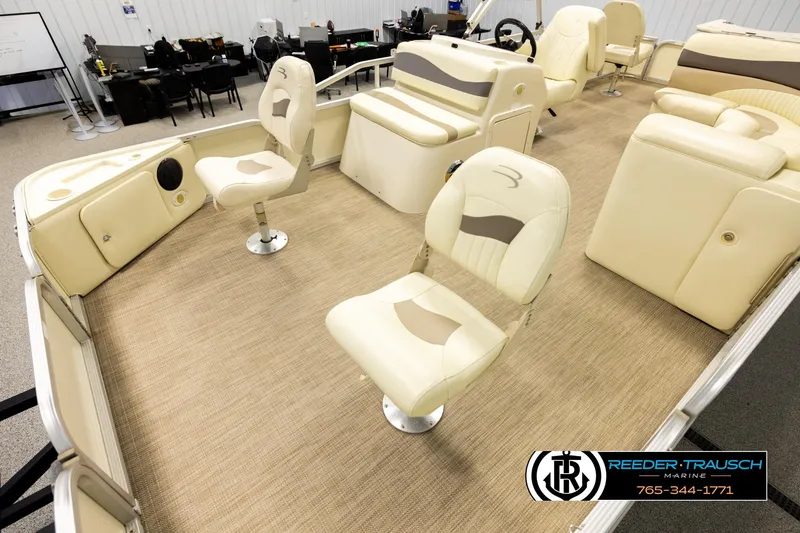 Slide: The Image of 2008 Bennington 2050 FSI boat interior with beige seating and carpet flooring. - 10