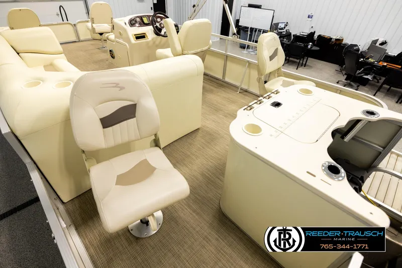 Slide: The Image of 2008 Bennington 2050 FSI boat interior with beige seating and steering console. - 11