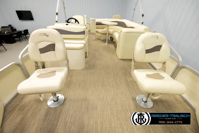 Slide: The Image of 2008 Bennington 2050 FSI boat interior with beige seating and carpeted flooring. - 13