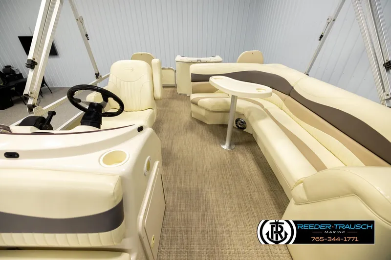 Slide: The Image of 2008 Bennington 2050 FSI pontoon boat interior with beige seating and steering wheel. - 14