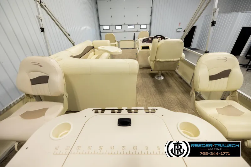 Slide: The Image of Interior of a 2008 Bennington 2050 FSI boat with beige seating and wood flooring. - 16